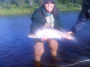 Monique Ouellet, wife of Jean Paul Ouellet, hooked this beautiful salmon on the Miramichi on August 9, 2011