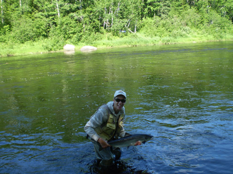 Stephen Miller releases a 12 pound salmon on the Northwest Miramichi Monday, July 2, 2012. 