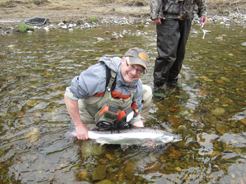 36 Inch, 18.2 pound salmon caught by Hilaire Chiasson of Lamèque NB on the Northwest Miramichi using a Green Machine White Tail. Photo by René Ferron.