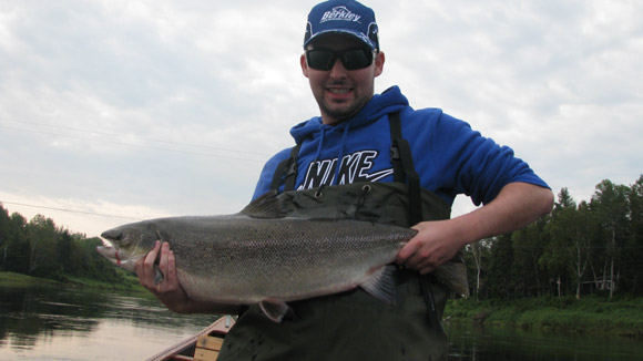 Jonathon Underhill hooking a salmon on a fly that he tied